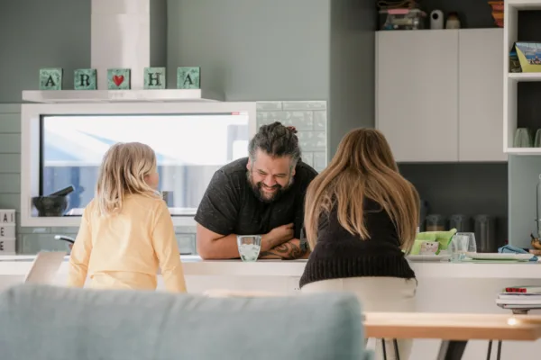 Smiling man universal design kitchen with children
